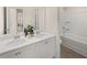 Bright bathroom with double sink vanity, quartz countertop, and tub and shower combo at 2198 Cormac St, East Point, GA 30344