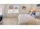 Bright bedroom featuring patterned bedspread, a sunny window, and a neutral color scheme at 2198 Cormac St, East Point, GA 30344