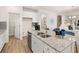 Beautiful kitchen island with stainless steel sink, breakfast bar and white cabinetry at 2198 Cormac St, East Point, GA 30344