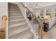 Elegant staircase with wooden handrail and carpeted steps, leading to the upper level at 2198 Cormac St, East Point, GA 30344