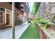 Scenic backyard with artificial turf, brick pavers, and a well-manicured garden, perfect for outdoor relaxation at 3280 Stillhouse Se Ln # 108, Atlanta, GA 30339