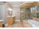 Bright bathroom featuring a walk-in glass shower, soaking tub, and modern vanity at 3280 Stillhouse Se Ln # 108, Atlanta, GA 30339