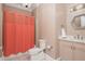 Well-lit bathroom with a shower, toilet, vanity with countertop, and a decorative mirror at 3280 Stillhouse Se Ln # 108, Atlanta, GA 30339