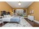 Sunlit bedroom features hardwood floors, french doors and windows leading to the landscaped grounds at 3280 Stillhouse Se Ln # 108, Atlanta, GA 30339