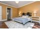 Cozy bedroom boasts hardwood floors, a decorative headboard, and ambient lighting at 3280 Stillhouse Se Ln # 108, Atlanta, GA 30339