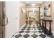 Inviting entryway featuring black and white tile flooring, a console table, and a view into the living room at 3280 Stillhouse Se Ln # 108, Atlanta, GA 30339