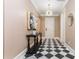 Charming hallway featuring black and white tile flooring, modern lighting, and a console table at 3280 Stillhouse Se Ln # 108, Atlanta, GA 30339