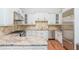 A bright kitchen with white cabinets, stainless steel appliances, granite countertops, and beautiful backsplash at 3280 Stillhouse Se Ln # 108, Atlanta, GA 30339