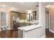 Modern kitchen featuring gray cabinets, stainless steel appliances, a breakfast bar, and hardwood floors at 3280 Stillhouse Se Ln # 108, Atlanta, GA 30339