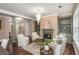 Bright living room featuring a fireplace, chandelier, hardwood floors, and built-in bookshelves at 3280 Stillhouse Se Ln # 108, Atlanta, GA 30339