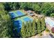 Aerial view showcasing the tennis courts surrounded by lush trees at 4481 Windsor Oaks Dr, Marietta, GA 30066