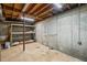 Unfinished basement with concrete walls, exposed ceiling, and industrial shelving provides ample storage space at 4481 Windsor Oaks Dr, Marietta, GA 30066