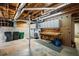 Unfinished basement featuring exposed wood beams, work bench, and concrete floor at 4481 Windsor Oaks Dr, Marietta, GA 30066