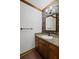 Cozy bathroom featuring a granite countertop, decorative accent wall, and dark wood cabinets at 4481 Windsor Oaks Dr, Marietta, GA 30066