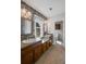 Bathroom featuring dual sinks, a granite countertop, mosaic tile, and wood cabinets at 4481 Windsor Oaks Dr, Marietta, GA 30066