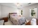 Bright bedroom featuring a bed, floral comforter, neutral walls and hardwood floors at 4481 Windsor Oaks Dr, Marietta, GA 30066