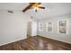 Bright bedroom featuring wood-look floors, a ceiling fan, and natural light from the double windows at 4481 Windsor Oaks Dr, Marietta, GA 30066