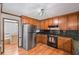 A kitchen featuring stainless steel appliances, warm wood cabinets and a functional layout at 4481 Windsor Oaks Dr, Marietta, GA 30066