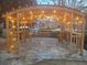 Outdoor pergola on stone patio with hanging lights, creating an inviting entertainment area at 4481 Windsor Oaks Dr, Marietta, GA 30066