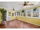 Bright sunroom with yellow beadboard and many windows providing natural light at 4481 Windsor Oaks Dr, Marietta, GA 30066