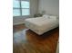 Bright bedroom with hardwood floors and natural light from large windows at 818 Burchill Sw St, Atlanta, GA 30310