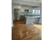 Modern kitchen with white and gray cabinets, stainless steel appliances, and hardwood floors at 818 Burchill Sw St, Atlanta, GA 30310