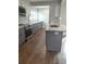 Kitchen with gray cabinets, stainless appliances, and granite countertop island at 818 Burchill Sw St, Atlanta, GA 30310