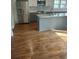 Well-lit kitchen with stainless steel appliances and island with granite countertops at 818 Burchill Sw St, Atlanta, GA 30310