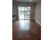 Hardwood floors lead to a deck and backyard views in this open-concept living space at 818 Burchill Sw St, Atlanta, GA 30310