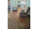 Bright living room featuring hardwood floors, neutral walls, and a view into the updated kitchen at 818 Burchill Sw St, Atlanta, GA 30310