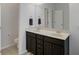 This bathroom includes a double sink vanity with dark wood cabinets and an overhead mirror at 108 Trailside Cir, Hiram, GA 30141