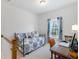 Small bedroom featuring a trundle bed, a nearby window, and a wood desk at 108 Trailside Cir, Hiram, GA 30141