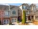 Townhome exterior with brick and siding, featuring a two-car garage and well-maintained landscaping at 108 Trailside Cir, Hiram, GA 30141