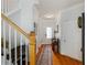 Bright hallway featuring hardwood floors, a staircase, and access to the front door at 108 Trailside Cir, Hiram, GA 30141