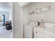 A view into the bright laundry room, with washer, dryer, and view into an adjacent bedroom at 108 Trailside Cir, Hiram, GA 30141