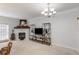 Bright living room with fireplace, decorative shelving, and a modern chandelier at 108 Trailside Cir, Hiram, GA 30141