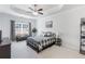 Spacious main bedroom features a tray ceiling, a ceiling fan, a bench beneath the window, and neutral-toned walls at 108 Trailside Cir, Hiram, GA 30141