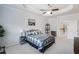 Bright main bedroom featuring carpeted floors, a ceiling fan, white walls, and trim, and a view into the hallway at 108 Trailside Cir, Hiram, GA 30141