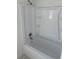 Bright bathroom featuring a white bathtub and shower with built in shelving at 1335 Tumblerock Way, Loganville, GA 30052