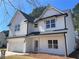 Charming two-story home boasting white siding, black trim, a two-car garage, and a welcoming entrance at 1335 Tumblerock Way, Loganville, GA 30052