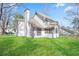 Exterior view of the home highlighting the backyard and screened in porch at 275 Carriage Chase, Fayetteville, GA 30214