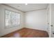 This bedroom boasts wood floors, large window, and closet at 275 Carriage Chase, Fayetteville, GA 30214