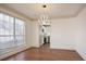 Bright dining room features hardwood floors, modern lighting fixture, and connects to kitchen at 275 Carriage Chase, Fayetteville, GA 30214