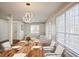 Staged dining room featuring hardwood floors, modern lighting fixture, table and large windows at 275 Carriage Chase, Fayetteville, GA 30214