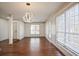 Bright dining room featuring hardwood floors, modern lighting fixture, and large windows at 275 Carriage Chase, Fayetteville, GA 30214