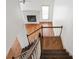 View from staircase to the living room with hardwood floors and a fireplace at 275 Carriage Chase, Fayetteville, GA 30214