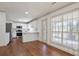 Open concept kitchen with white cabinets, stainless appliances, breakfast bar, and hardwood floors at 275 Carriage Chase, Fayetteville, GA 30214