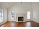 Bright living room with wood floors, a fireplace, and large windows at 275 Carriage Chase, Fayetteville, GA 30214