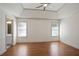 Spacious main bedroom with ensuite entrance, two windows, and hardwood floors at 275 Carriage Chase, Fayetteville, GA 30214