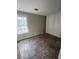 Cozy bedroom with ample natural light and stylish accent wall panels and stone-look flooring at 404 Prince Of Wales, Stone Mountain, GA 30083